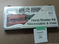 Front view of sealed hand riveter kit showing tool and rivets