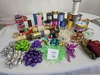 Table of ribbon spools, bows and bow maker