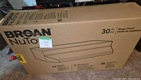 Sealed shipping box showing Broan NuTone branding and 30 in. specification