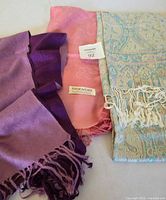 Three pashmina scarves purple, pink and aqua paisley
