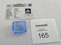 Front view of large blue topaz and certificate