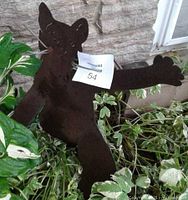 Front view of steel cat yard sculpture among plants