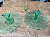 Two handled platters and juice glass on table