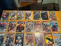All 21 Superman-related comics laid out in four rows on table
