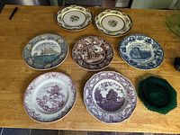 All eight plates arranged on table for overview