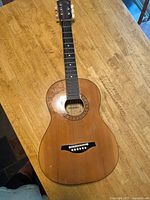 Full view of guitar front showing size and overall condition