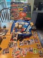 Boxed Strike Zone game, board, balls, tin, cards spread on table