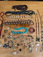 Group shot showing necklaces, brooches, rings, earrings, bracelet, medallion