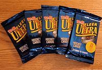 Five sealed 1992-93 Fleer Ultra Series II hockey card packs displayed on wooden surface