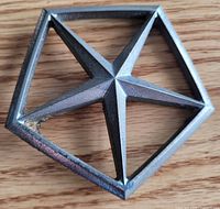 Front of Chrysler Pentastar hood ornament showing design and finish