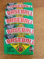 Front view of five sealed 1989 Bowman Baseball wax packs stacked on wooden surface