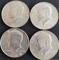 Obverse of four Kennedy half dollars dated 1966, 1967, 1968, 1969