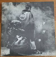 Front gatefold cover featuring rider on scooter