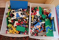 Overview of two bins filled with assorted Lego pieces
