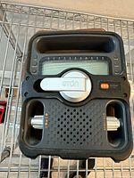 Front view of Eton Solarlink FR-500 emergency radio showing hand crank folded, speaker grille and display