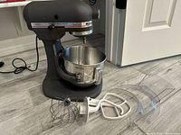 Mixer with bowl and attachments displayed