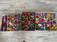 Three open storage boxes showing all ornament compartments