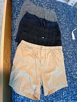 Stack of five shorts in various colors