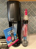 Front view SodaStream Terra with manual, bottle, cylinder