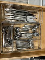 Top view of entire cutlery set in wire organizers showing knives, forks, tablespoons, teaspoons