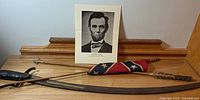 Group view of sword, arrows, flag, Lincoln photo