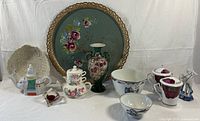 Group shot of entire lot showing vase, tray, teapots, bowls, cups, figurine, glass heart