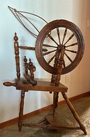 Full view of wooden spinning wheel showing all main parts