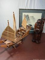 Full view of sailing ship model, watercolor painting, and rosewood statue