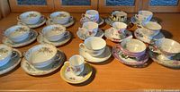 Overview of all teacup and saucer sets arranged on table
