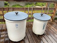 Both stoneware crocks with lids side by side showing size and markings