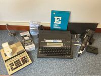Group shot showing all electronics, supplies, binder and cover