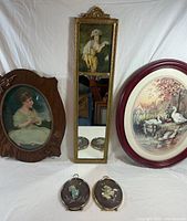 Group shot showing mirror with portrait, two large oval prints, two small floral plaques