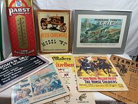 Group shot showing framed railway print, Pabst sign, tractor poster and assorted posters