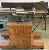 Front view of Delta Milwaukee jointer on wooden cabinet
