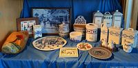 Full lot showing ceramic canisters, plates, framed items and wooden clog displayed together