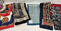 Five scarves laid out showing variety and Chanel label visible