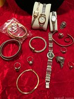 Overview of all wristwatches, bracelets, rings and pendant on red cloth