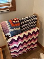 Rack holding three afghans