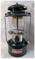 Front view of Coleman 290A lantern showing mantles, glass globe and control knob