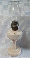 Full view of milk glass oil table lamp with chimney