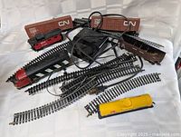 Lot overview showing locomotive, caboose, CN boxcars, gondola, tank car, transformer and track