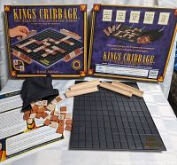 Front of box, board, tiles, racks, bag and instructions displayed