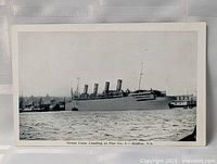 Full view of postcard front showing ocean liner and caption