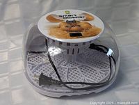 Incubator overall view showing clear dome, base and power cord