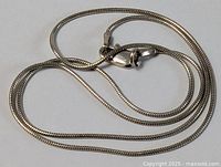 Coiled view showing clasp and chain texture