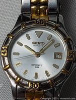 Dial close-up showing brand, Sports 50 text, bezel numerals