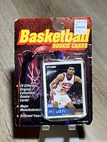 Front view of unopened Megacards Basketball Rookie Cards blister pack showing header card and visible rookie card on top