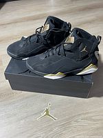 Pair of shoes on top of box with sticker; shows overall condition and included items