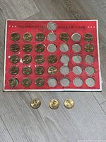 Board with coins and three loose coins on floor