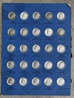 Album page with 25 dimes 1965-1973 range, edge wear visible